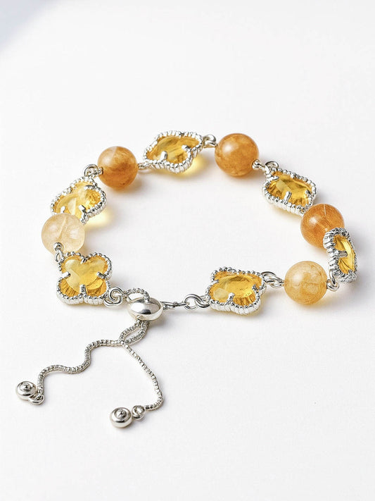 Bracelet with yellow beads and silver clasp on a white background