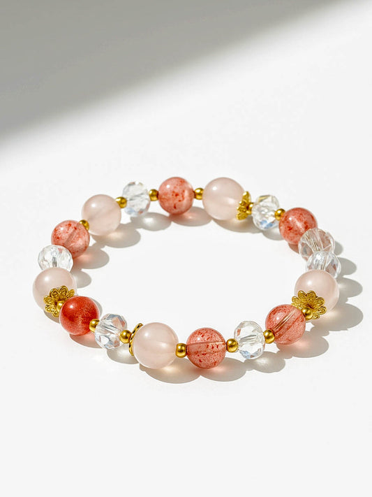 Beaded bracelet with pink, clear, and gold beads on a white background