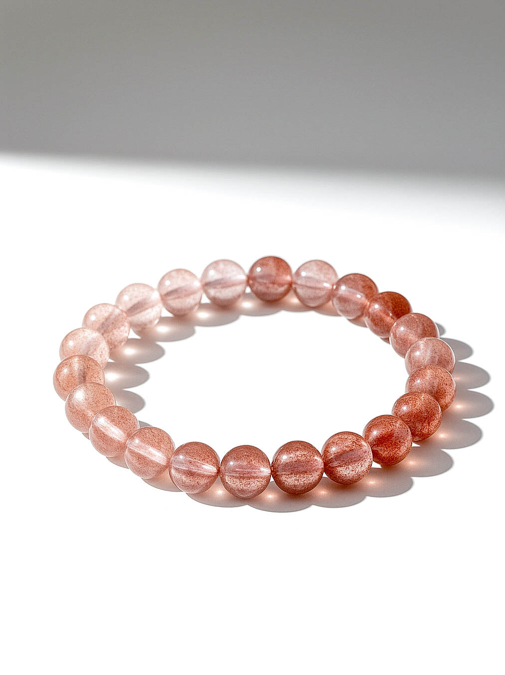 Pink beaded bracelet on a white background