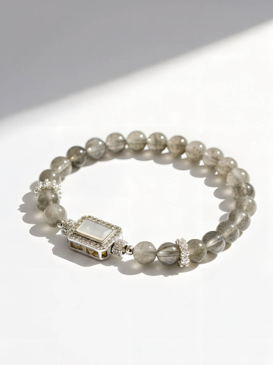 Beaded bracelet with a rectangular clasp on a white background