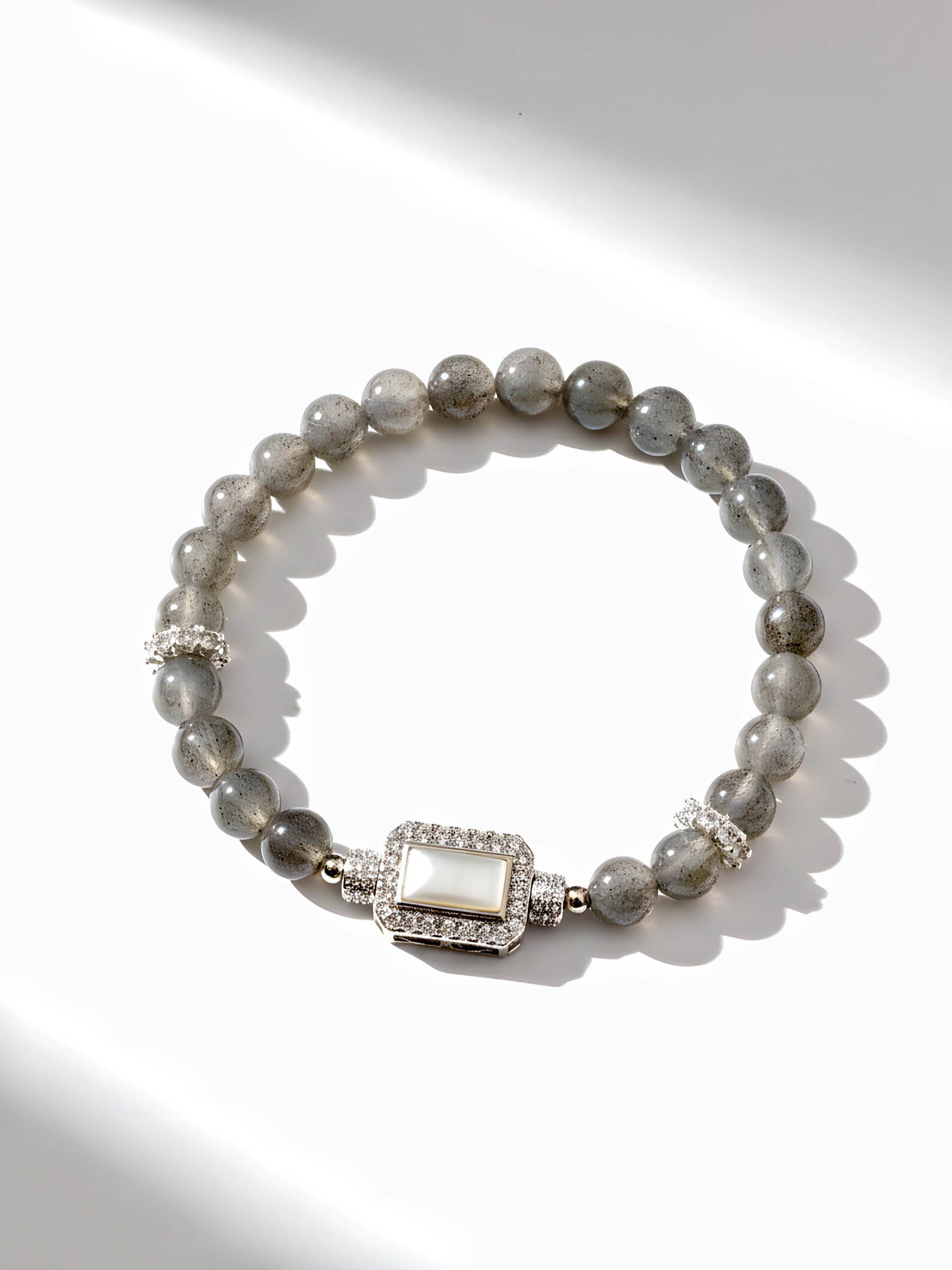 Gray beaded bracelet with a decorative clasp on a white background