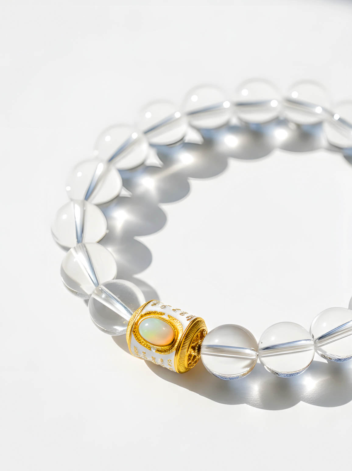 Bracelet with clear beads and a gold clasp on a white background