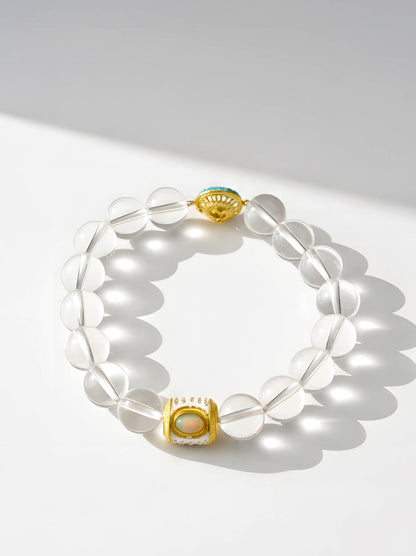 Clear beaded bracelet with gold accents on a white background