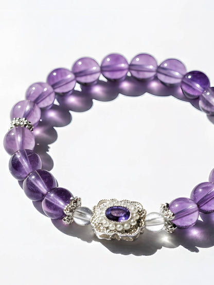 Purple beaded bracelet with a decorative clasp on a white background