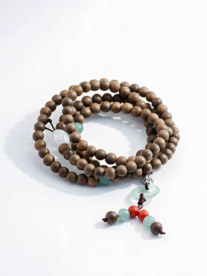 Wooden beaded necklace with colorful accents on a white background