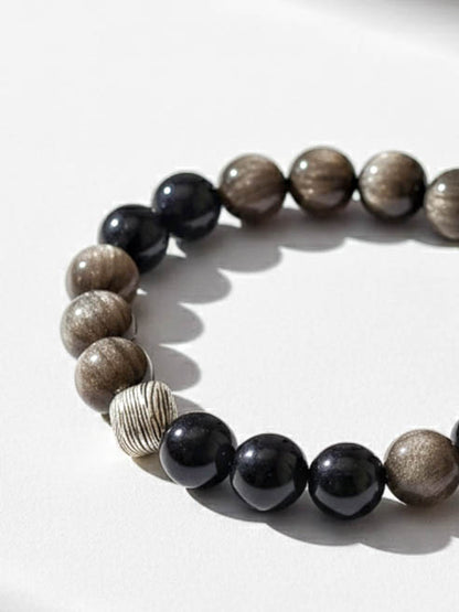 Bracelet with brown and black beaded design on a white background