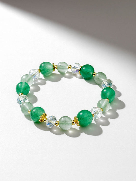 Green beaded bracelet with gold accents on a white background