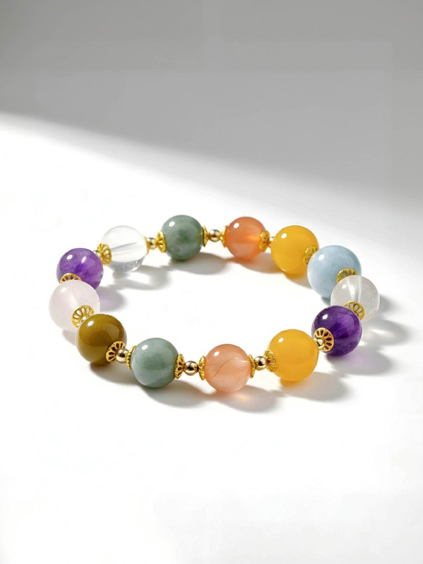 Multicolored beaded bracelet with gold accents on a white background