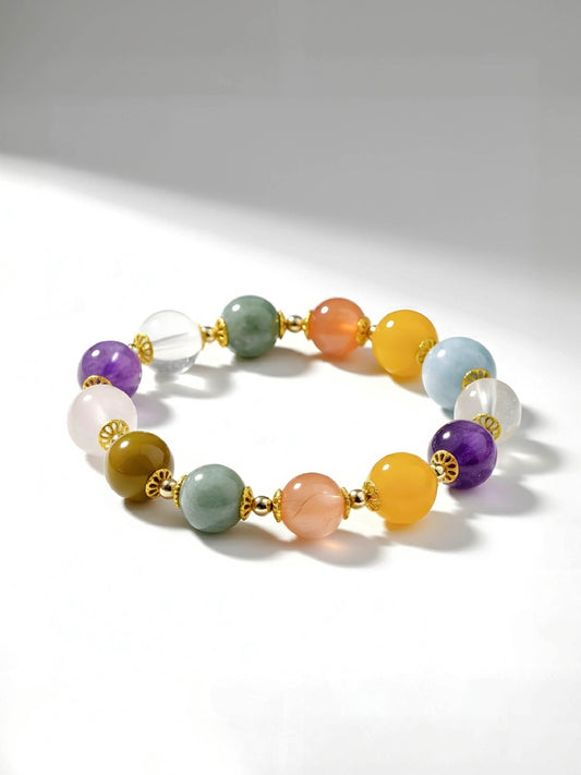 Multicolored beaded bracelet with gold accents on a white background