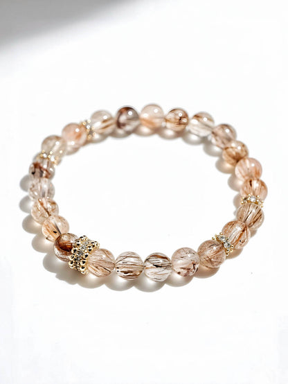 Beaded bracelet with gold accents on a white background