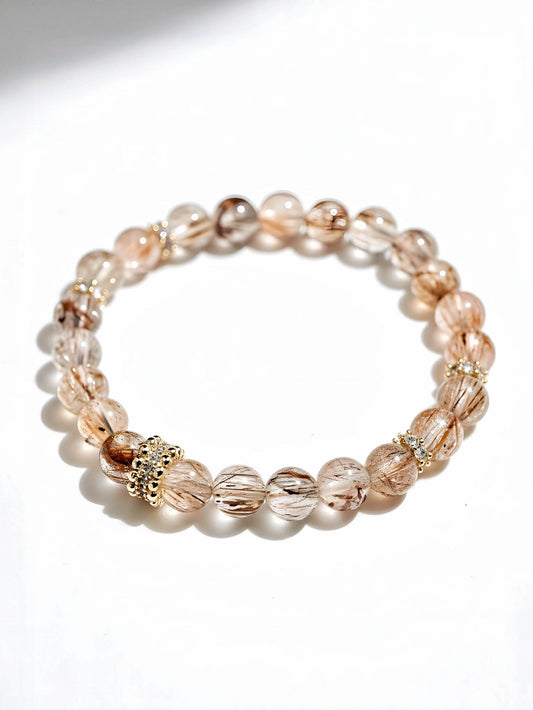 Beaded bracelet with gold accents on a white background