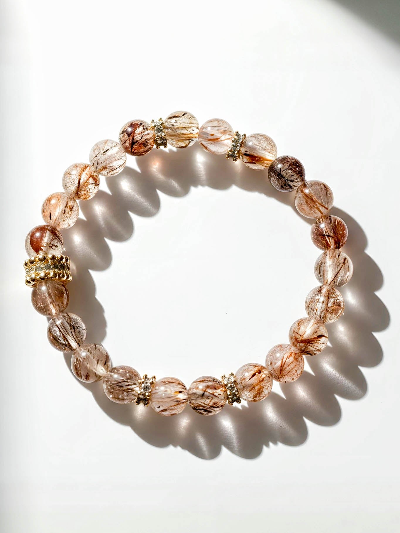 Beaded bracelet with gold accents on a white background