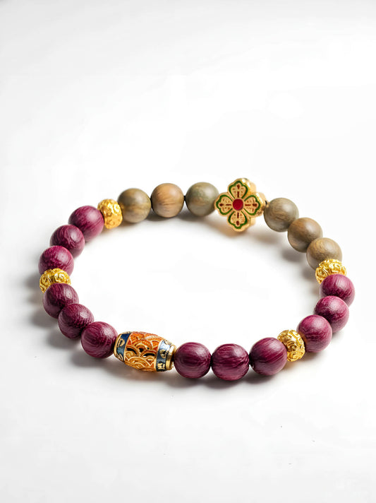 Bracelet with purple beads and gold accents on a white background