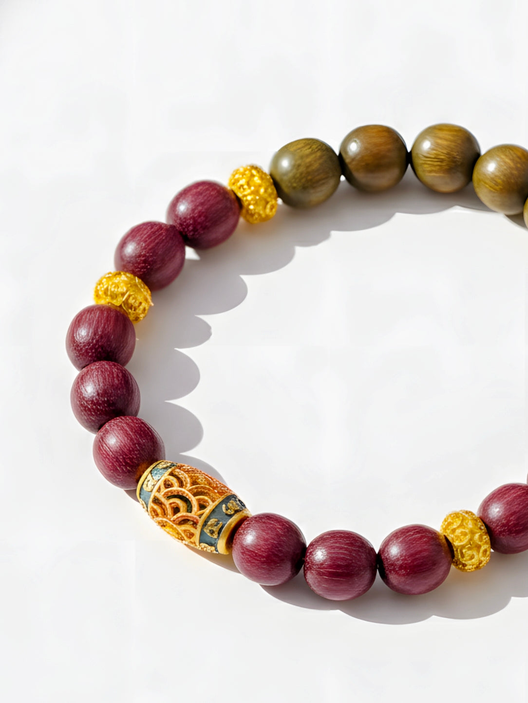 Bracelet with wooden beads and gold accents on a white background