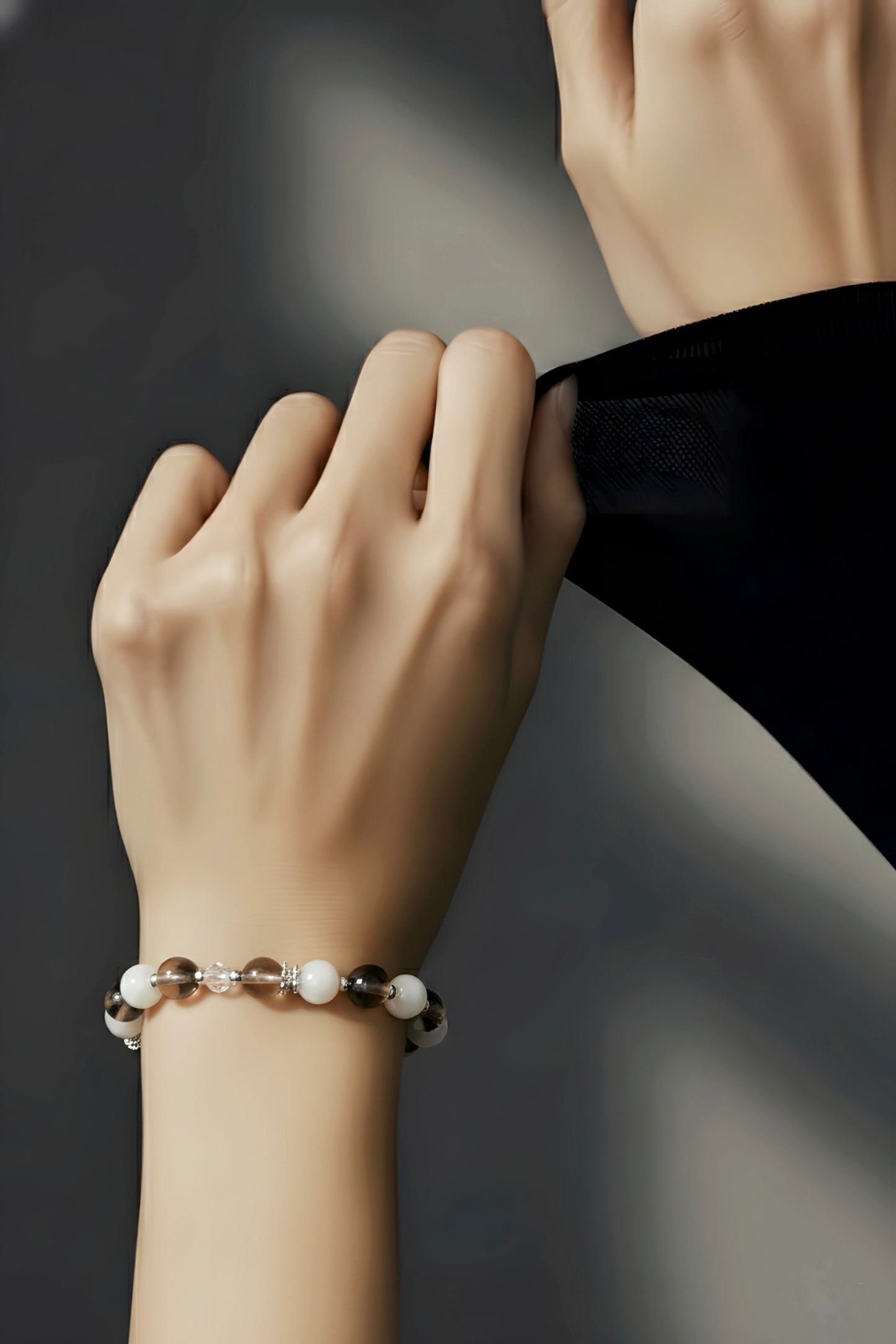 Close-up of a hand wearing a bracelet with a blurred background