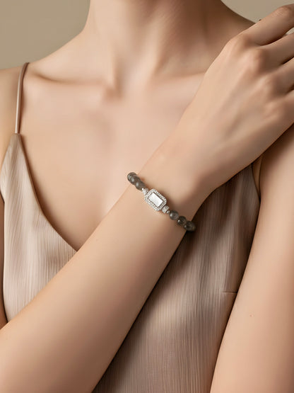 Bracelet on a woman's wrist with a neutral background