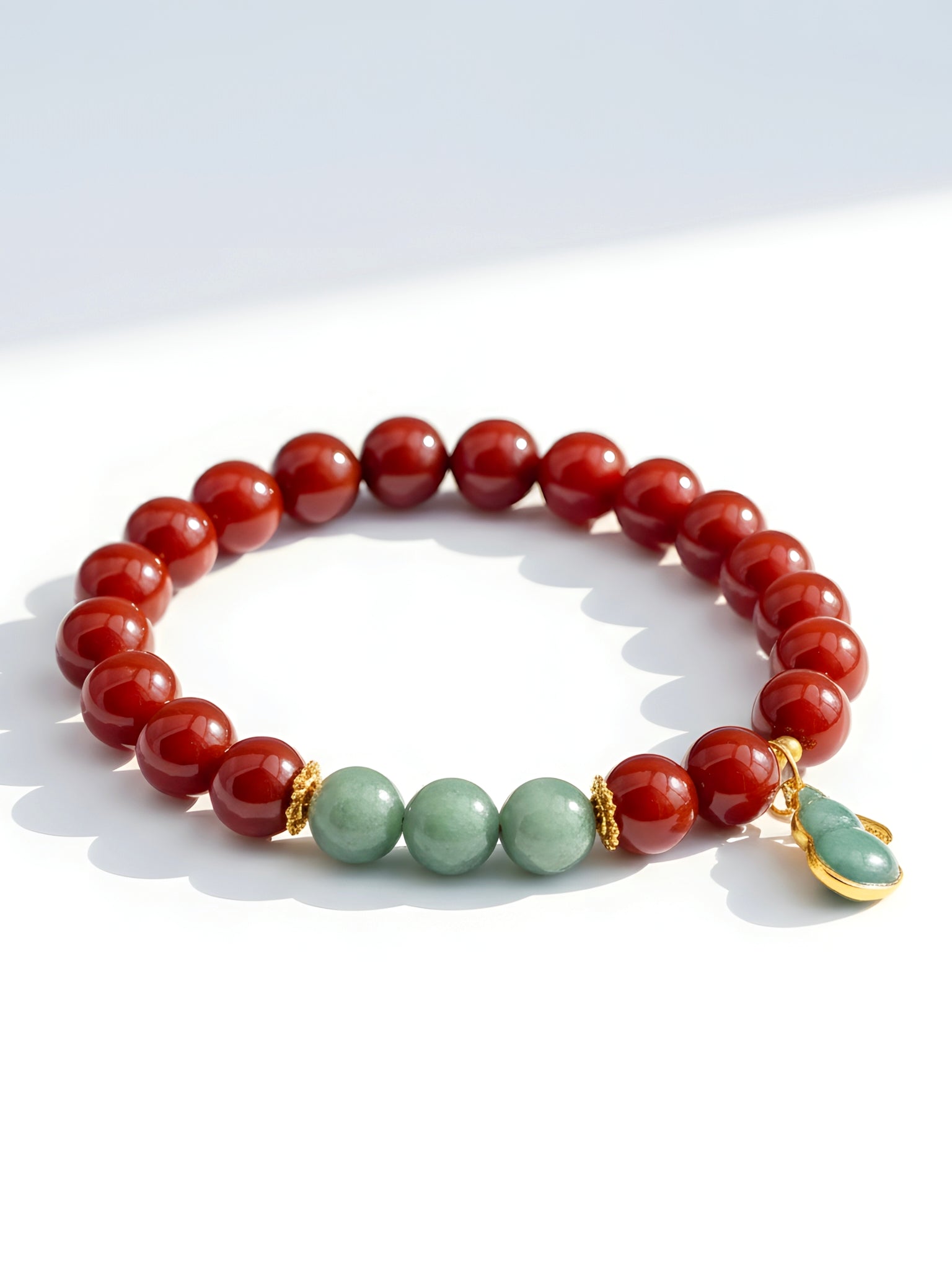 Bracelet with red and green beads on a white background