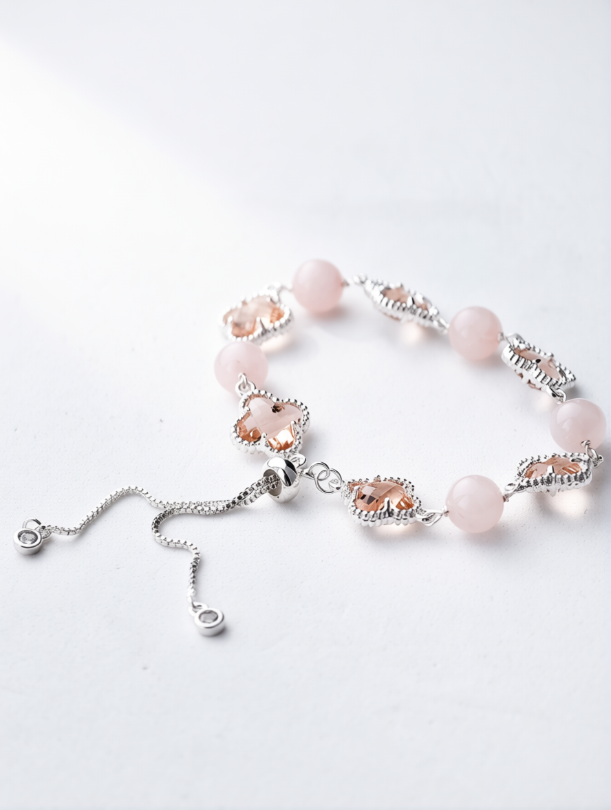 Bracelet with pink beads and silver chain on a white background