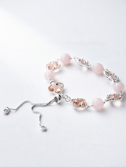 Bracelet with pink beads and silver chain on a white background