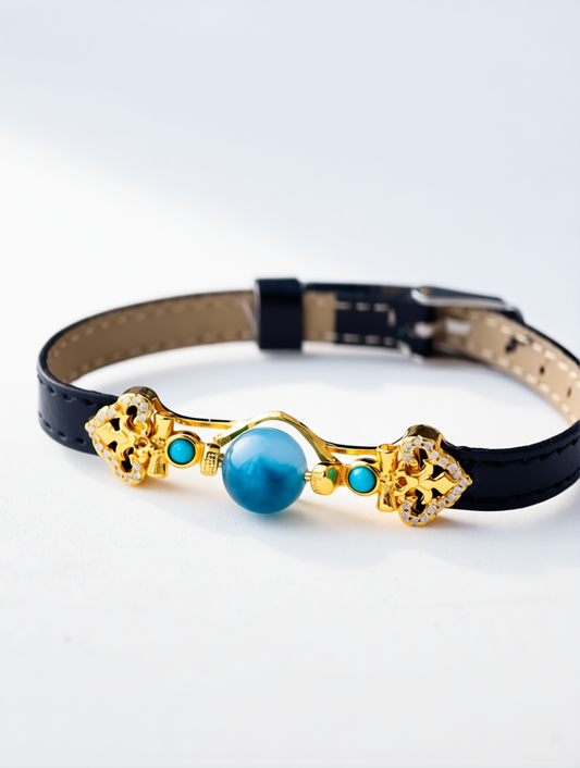 Black leather choker with gold and turquoise accents on a white background