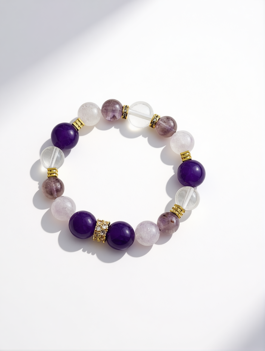 Beaded bracelet with purple and clear beads on a white background